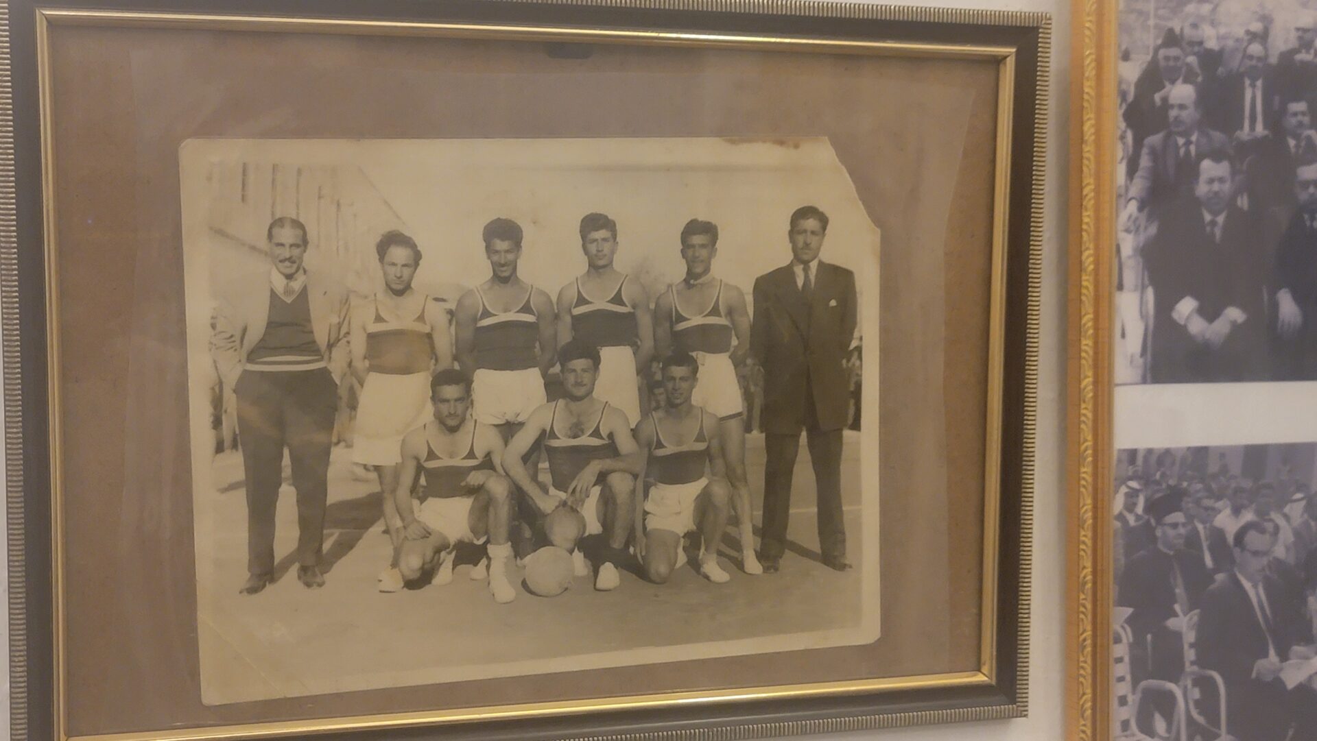 a group of men in sports uniforms posing for a picture