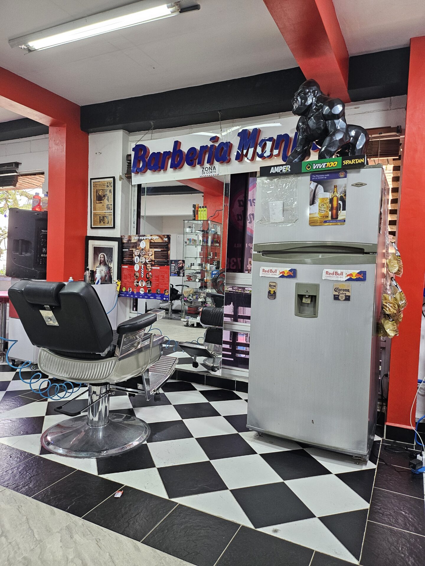 a barber shop with a chair and a refrigerator