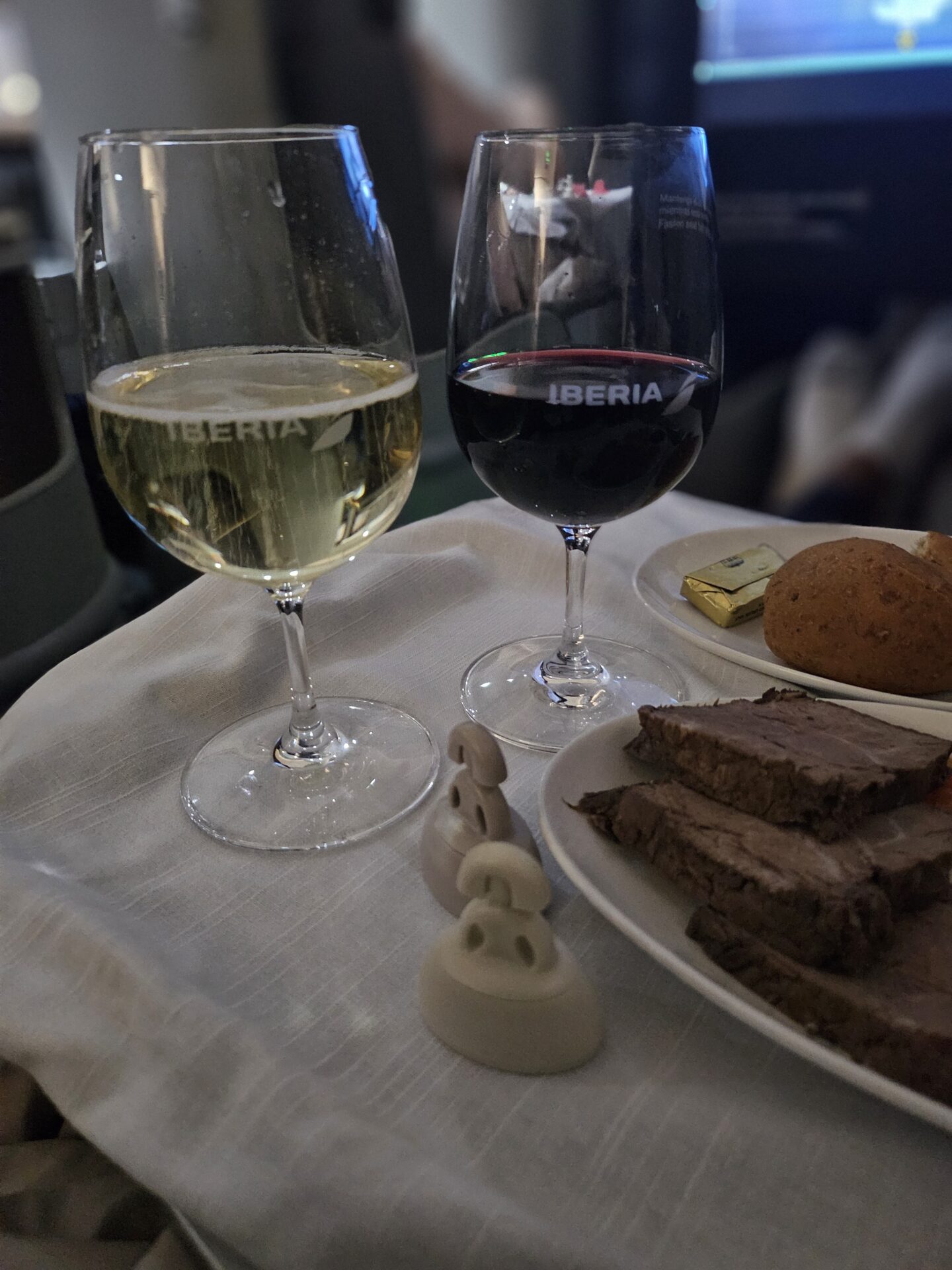 a plate of food and wine glasses on a table