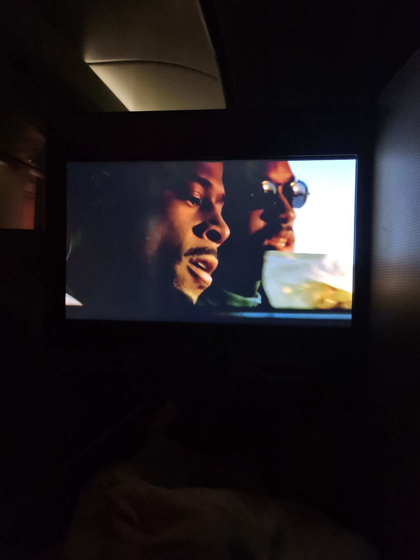 a tv screen with a couple of men in sunglasses