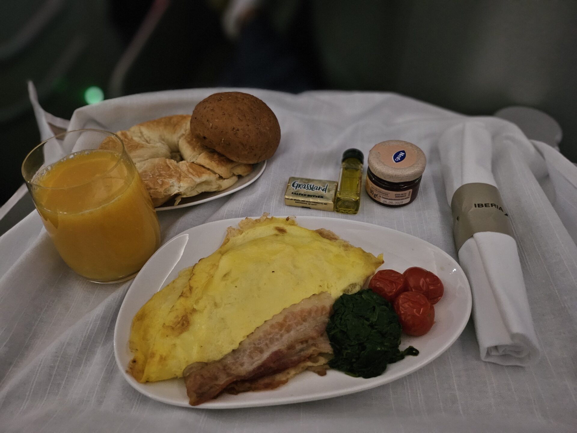 a plate of food and a glass of juice on a table