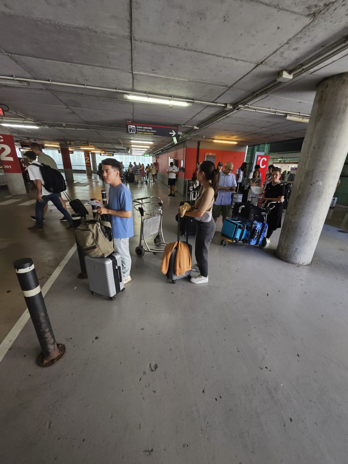 people with luggage in a parking lot