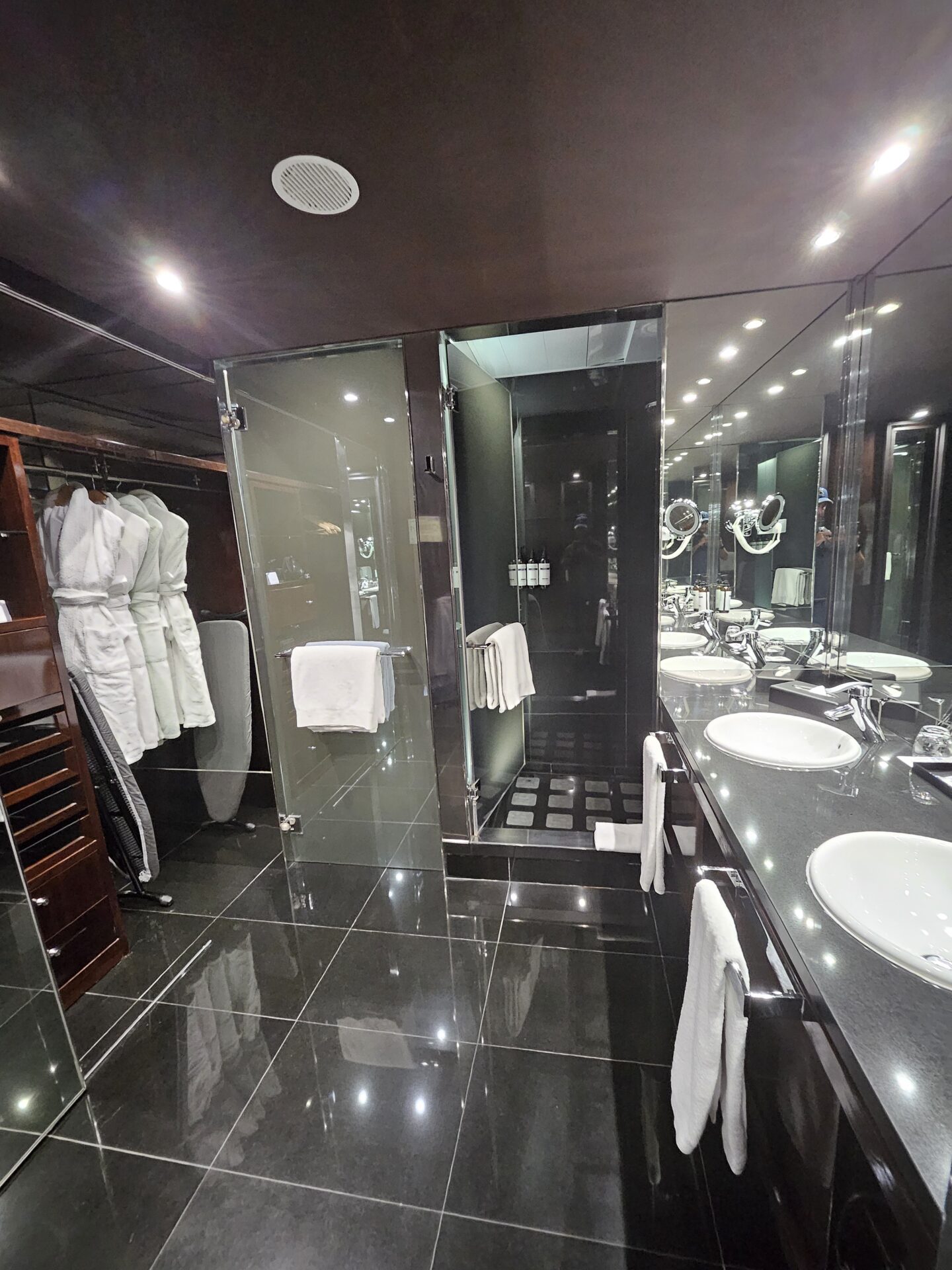 a bathroom with black tile floor and black countertops