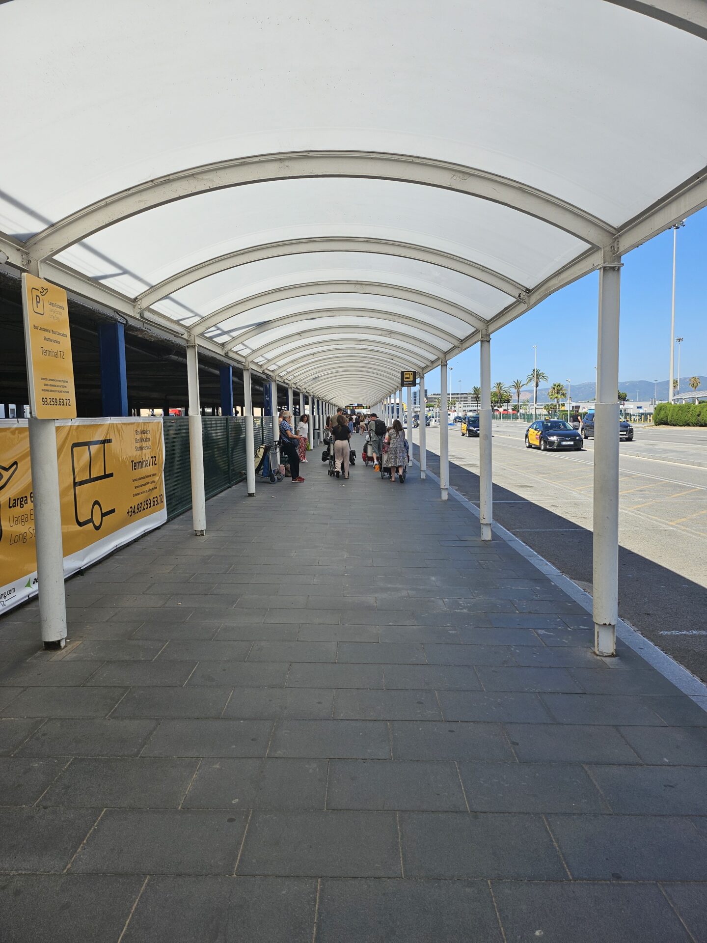 a group of people walking under a covered walkway