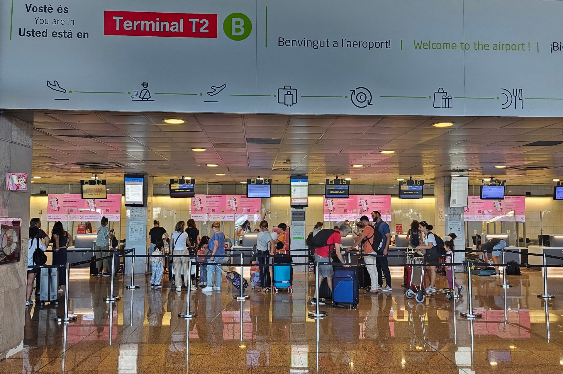 a group of people standing in a line in a terminal