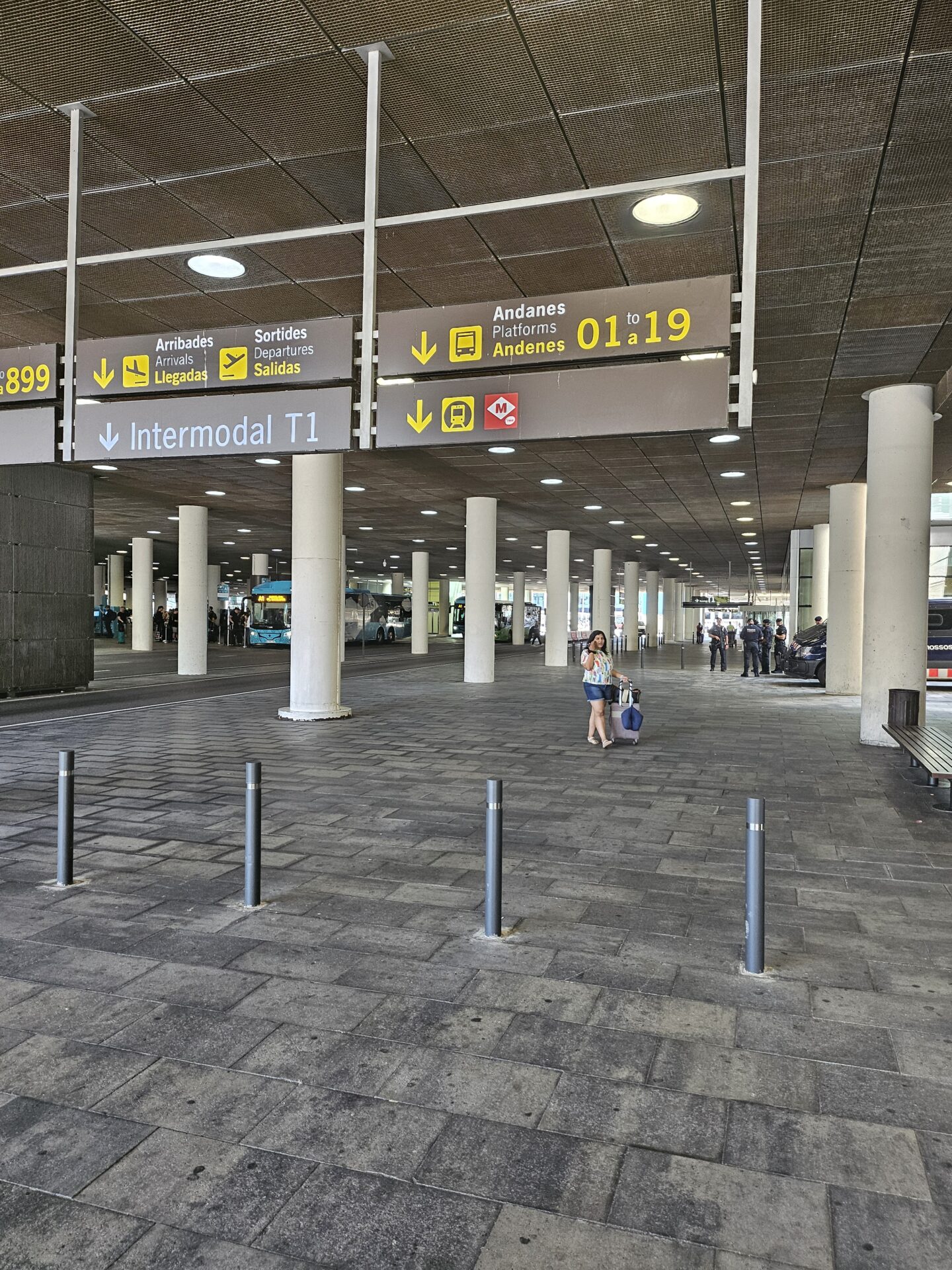 a woman in a large building with signs and columns