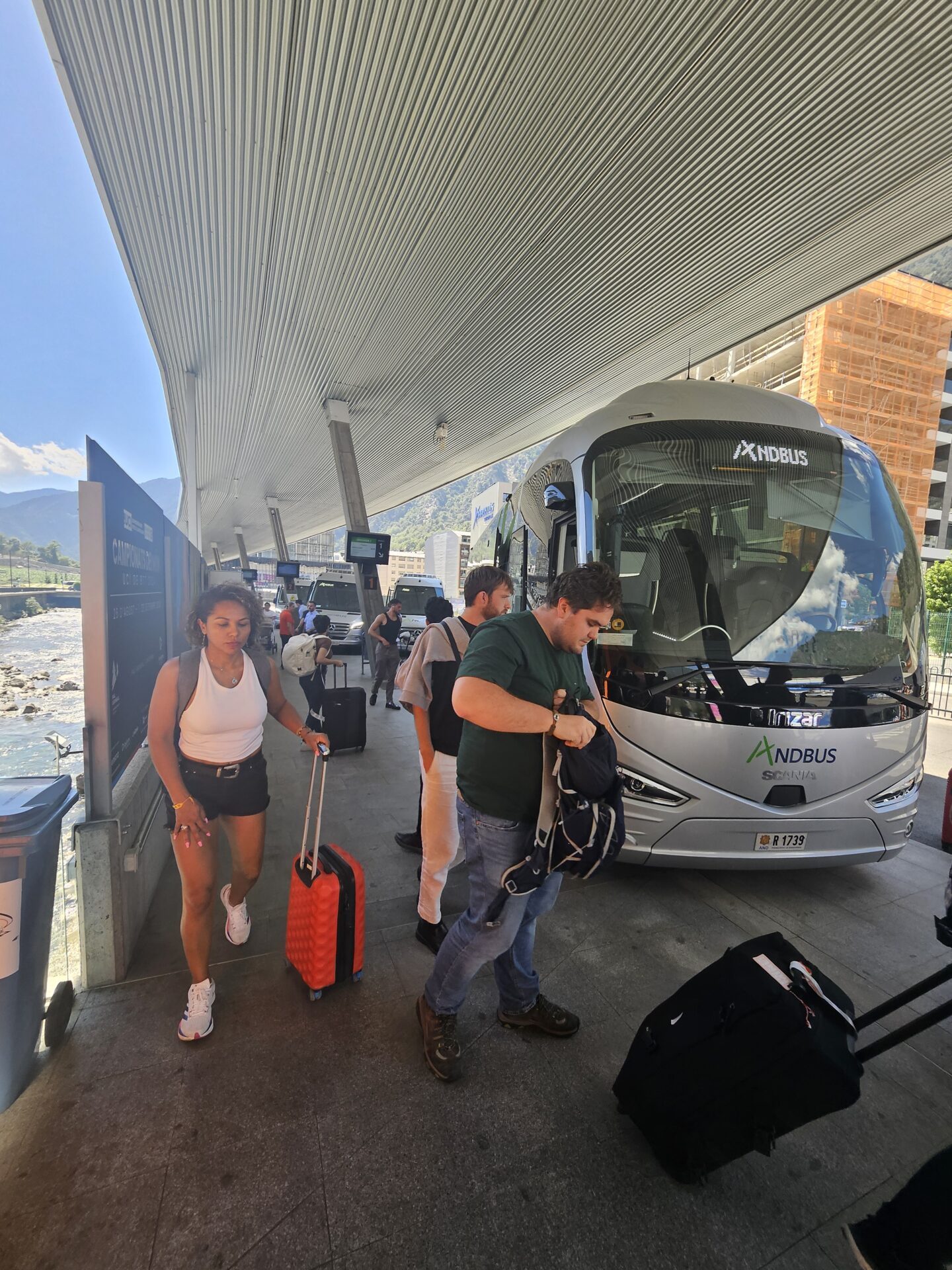 people standing next to a bus