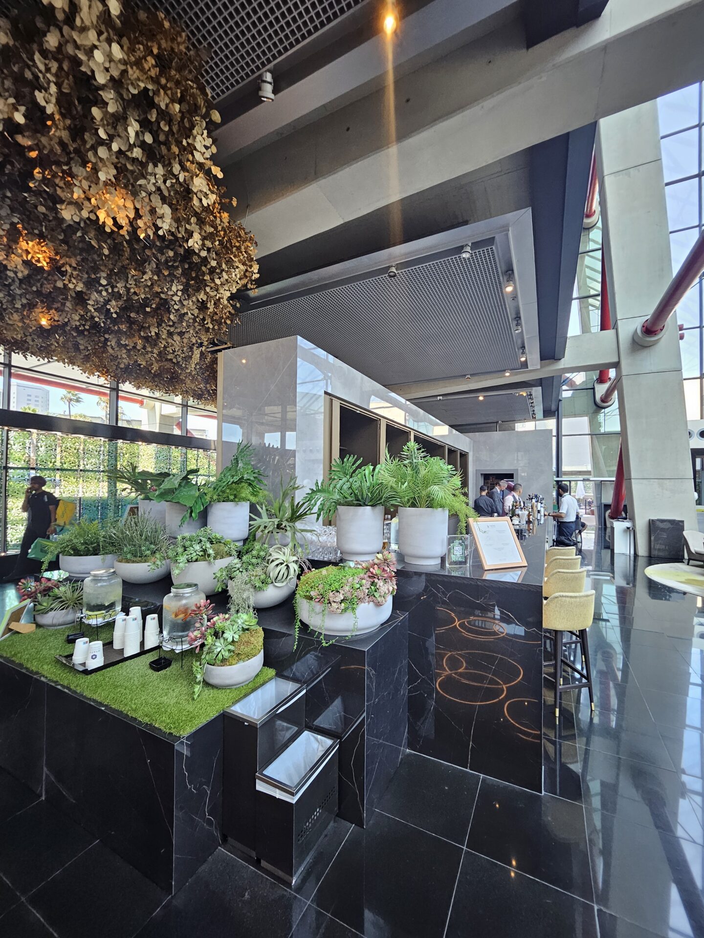 a room with a large window and a large building with plants