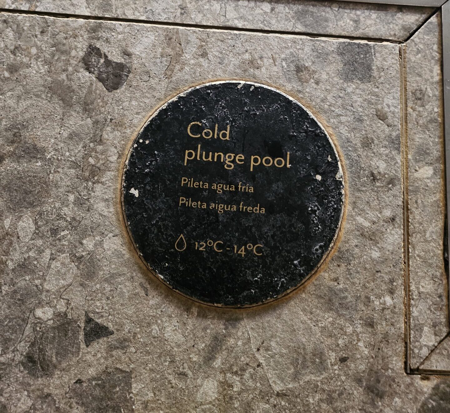 a sign on a stone surface