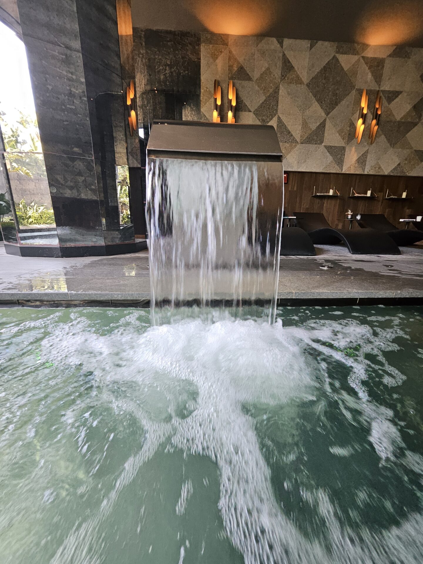 a waterfall in a pool