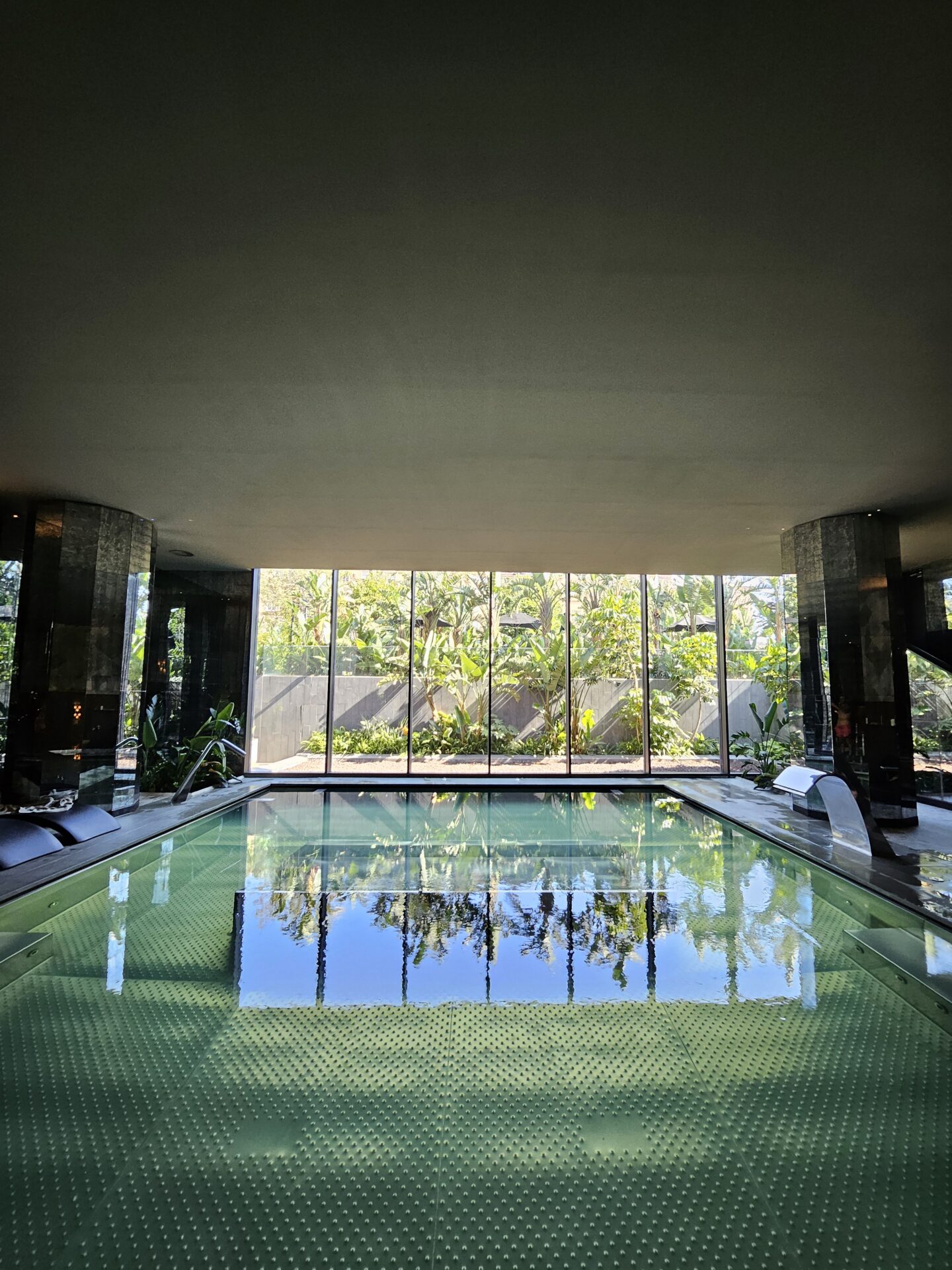 a indoor pool with a large window