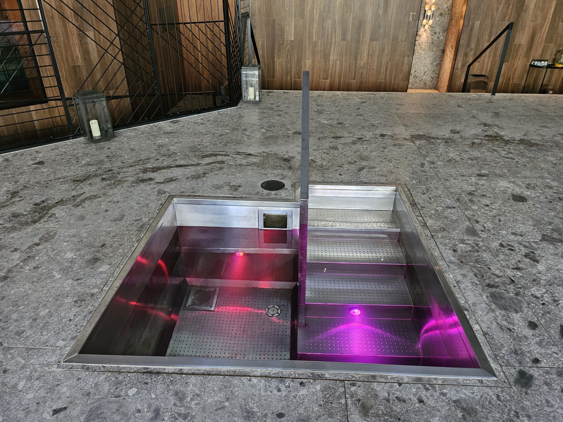 a rectangular metal pool with purple lights