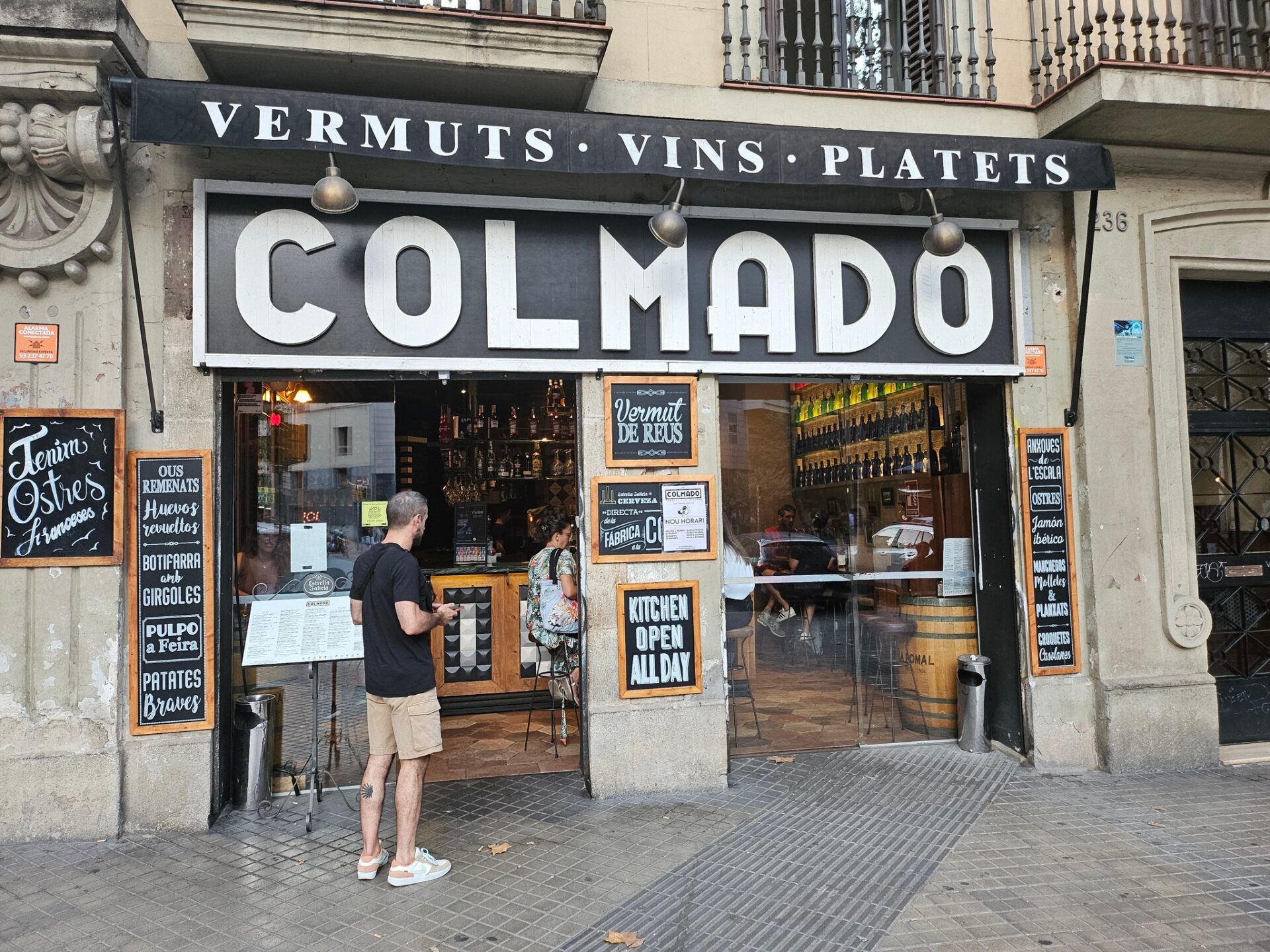 a man standing outside of a restaurant