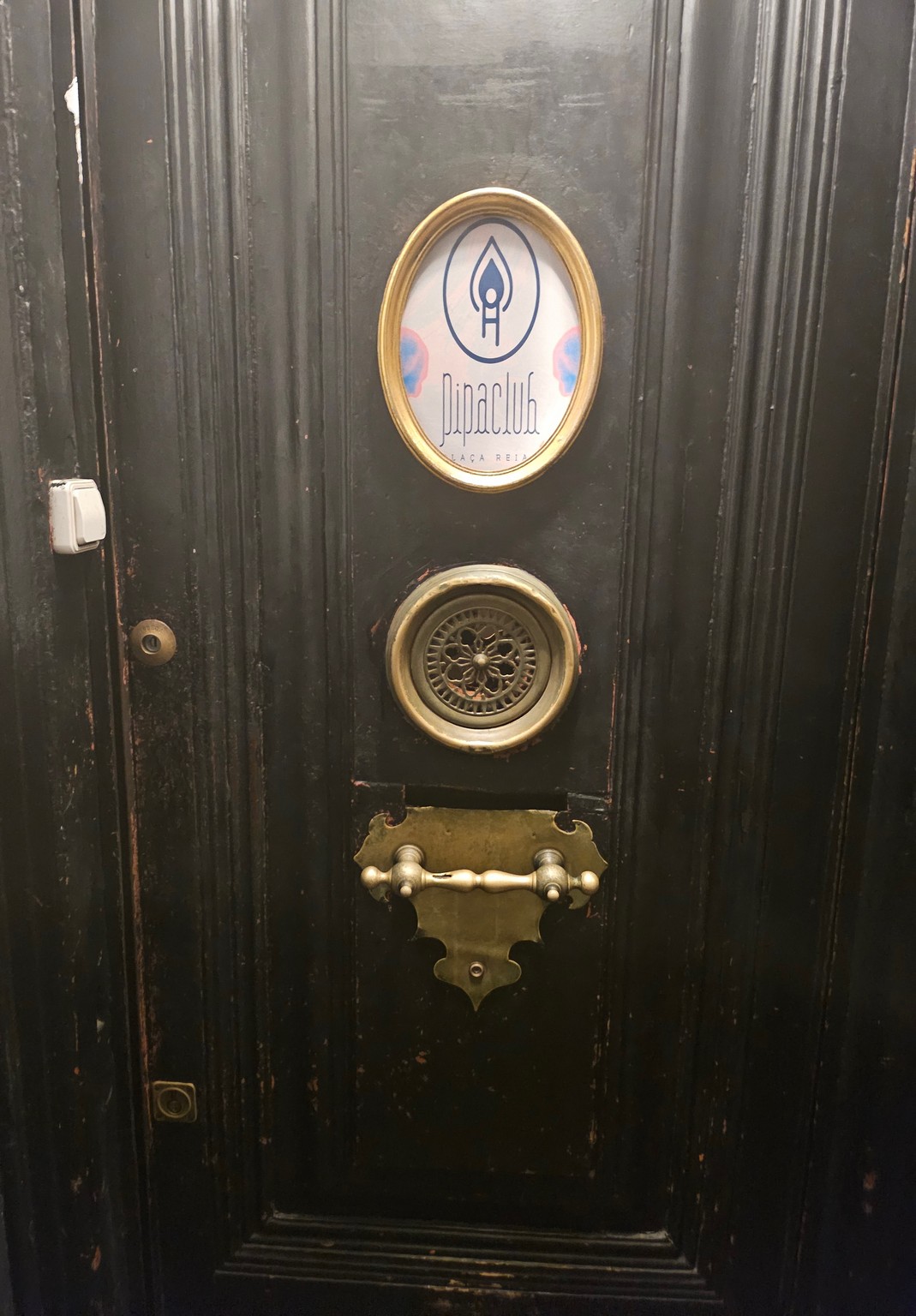 a door with a round sign and a hole in the middle