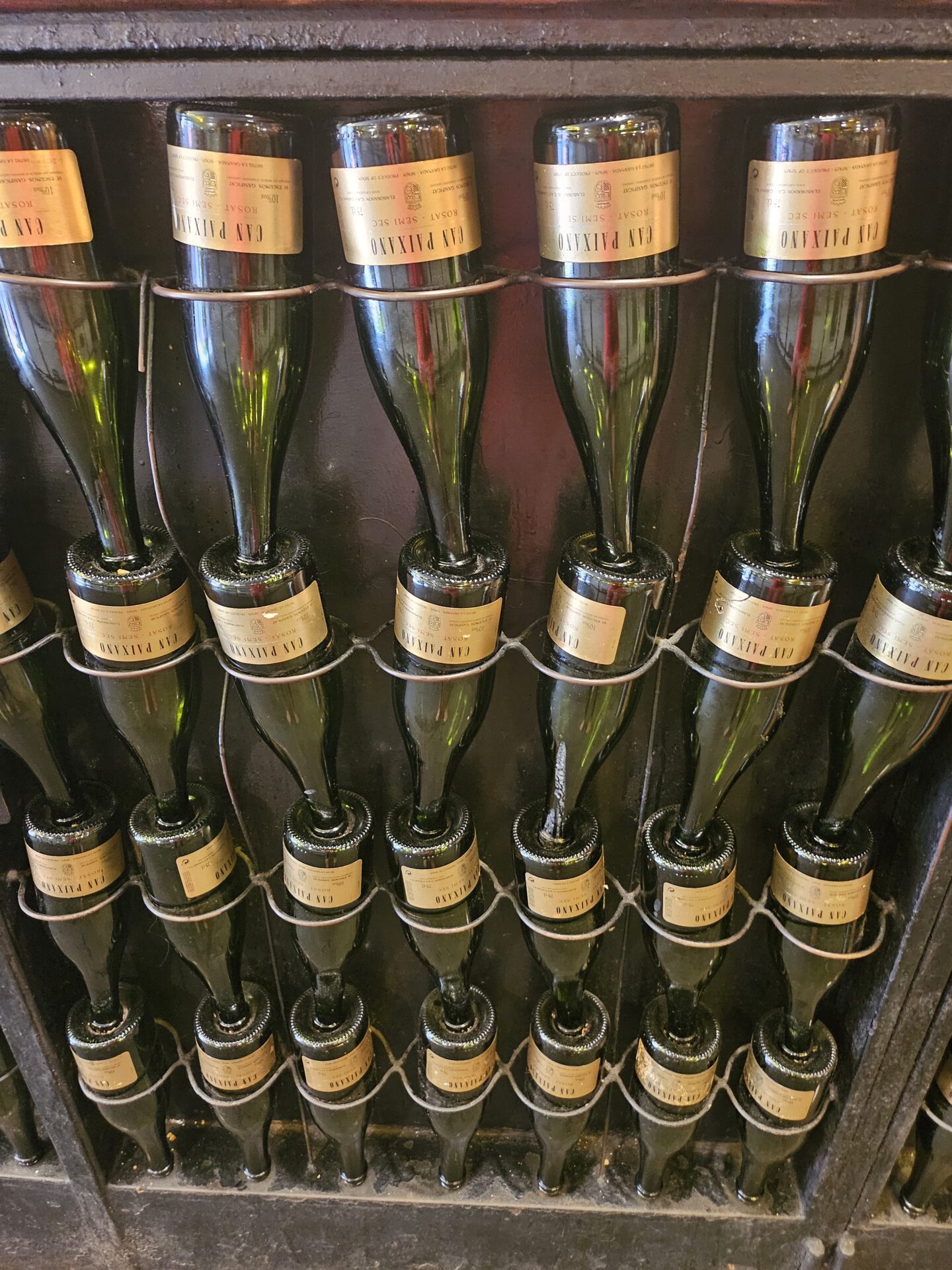 a group of wine bottles on a rack