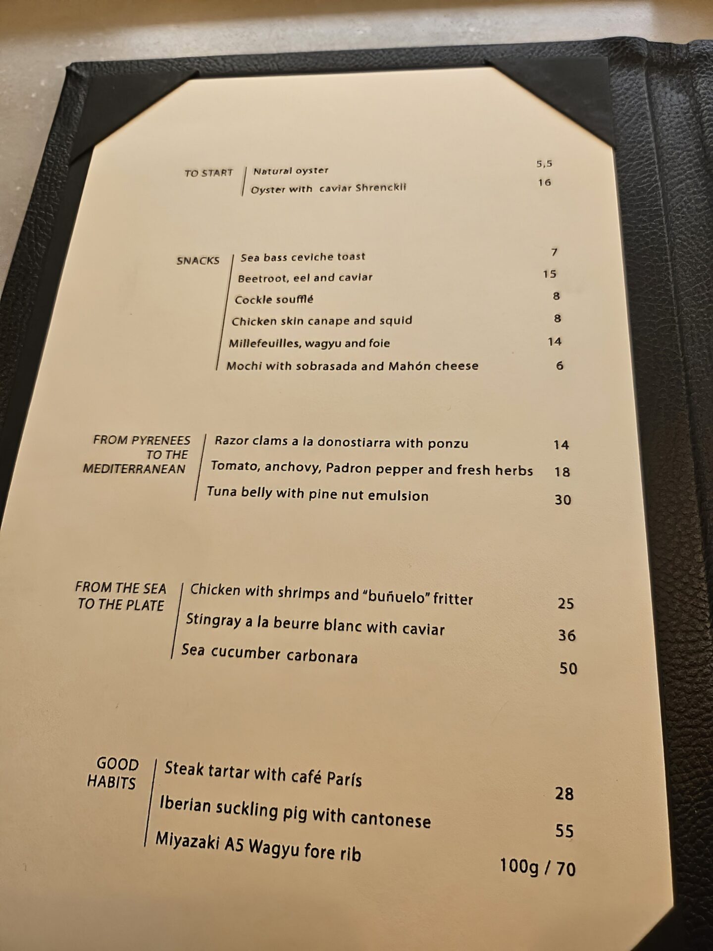 a menu on a black leather cover