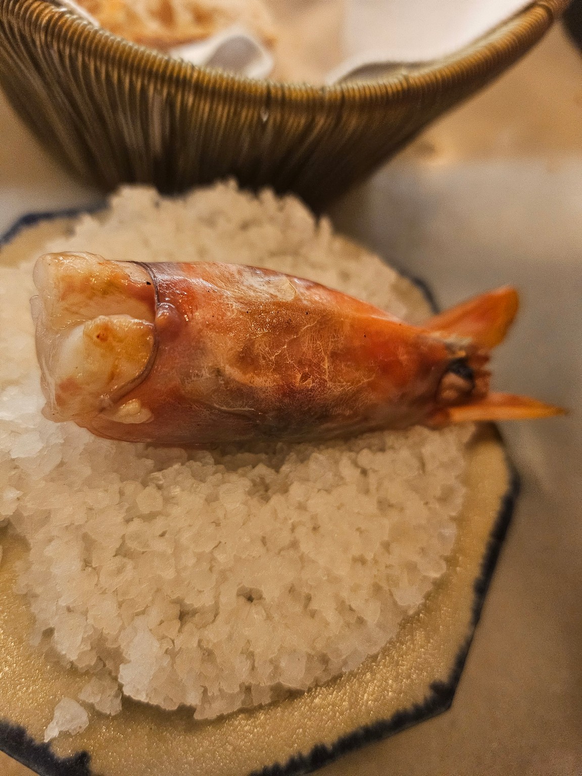 a cooked shrimp on a pile of salt