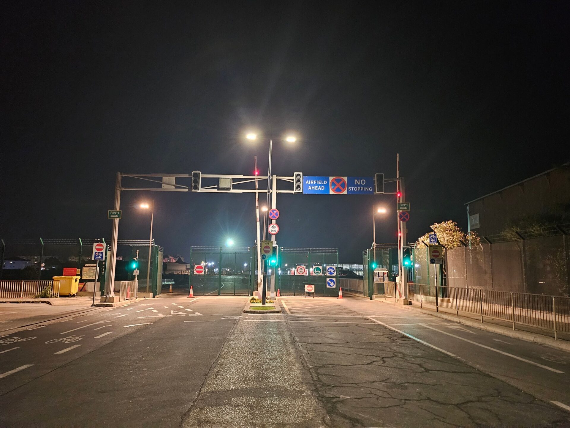 a street with signs and a gate