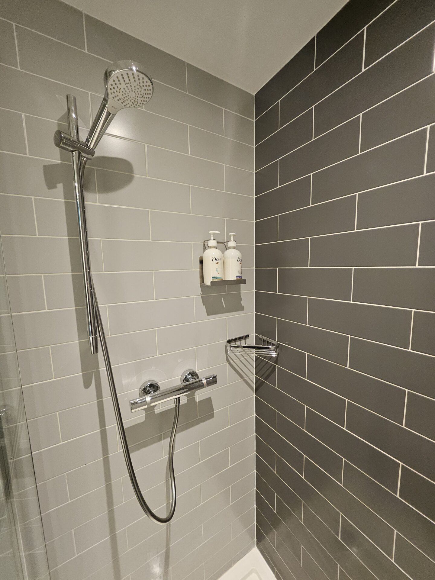 a shower with a shower head and a shower head