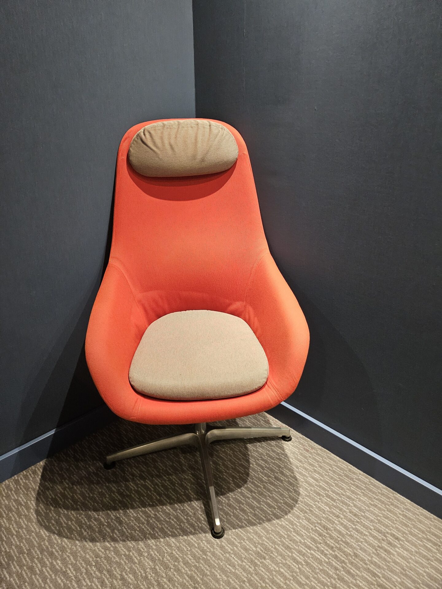 an orange chair in a corner