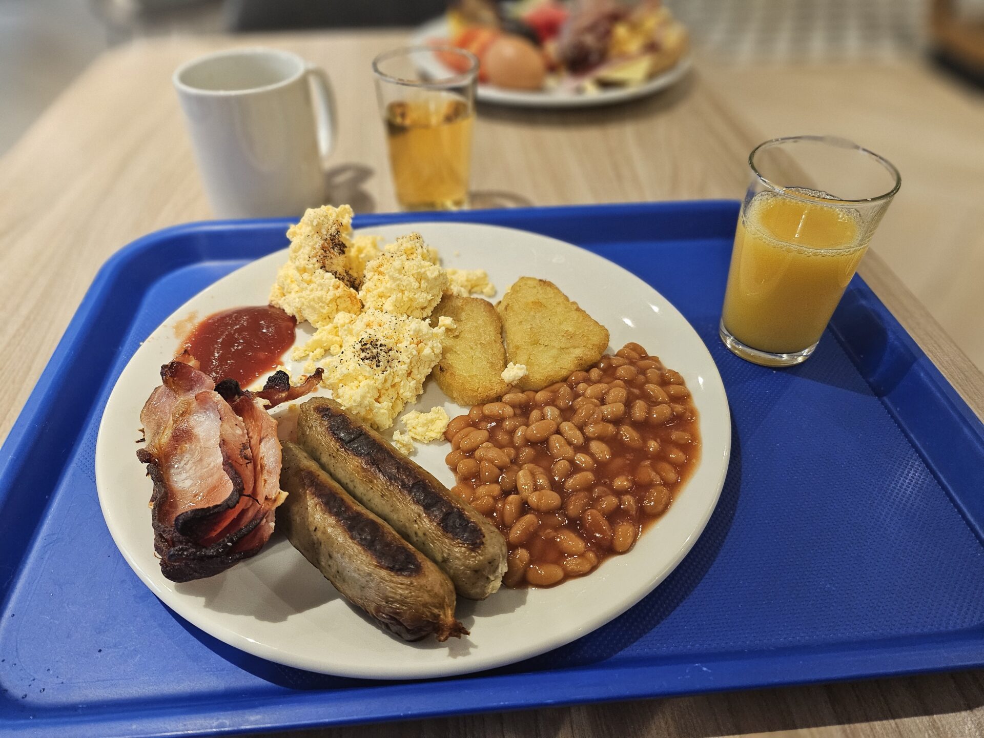 a plate of breakfast food and drinks on a tray