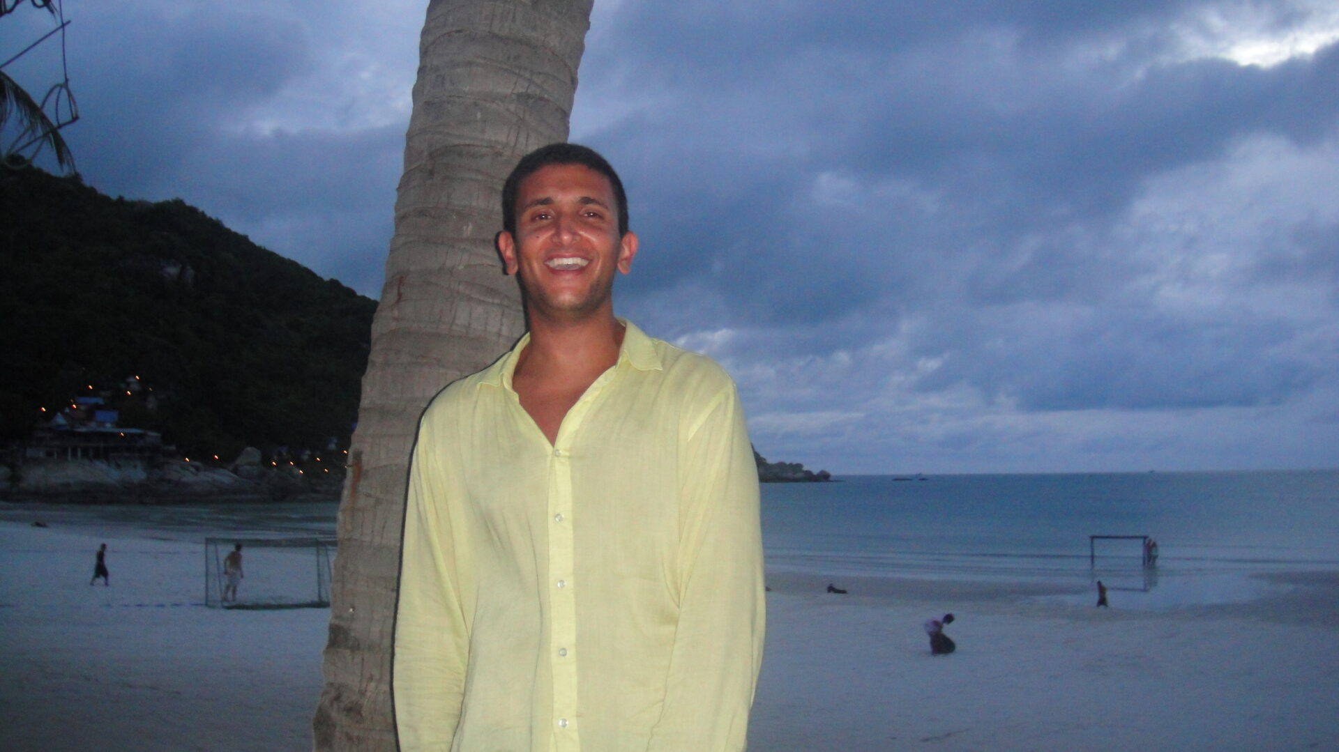 a man standing next to a tree