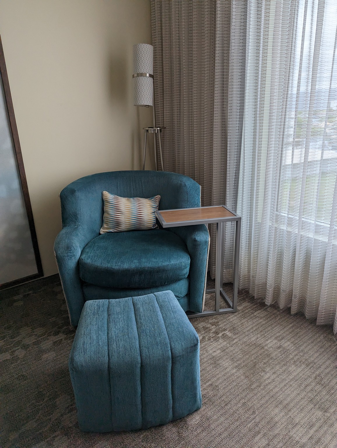 a blue chair and ottoman in a corner of a room