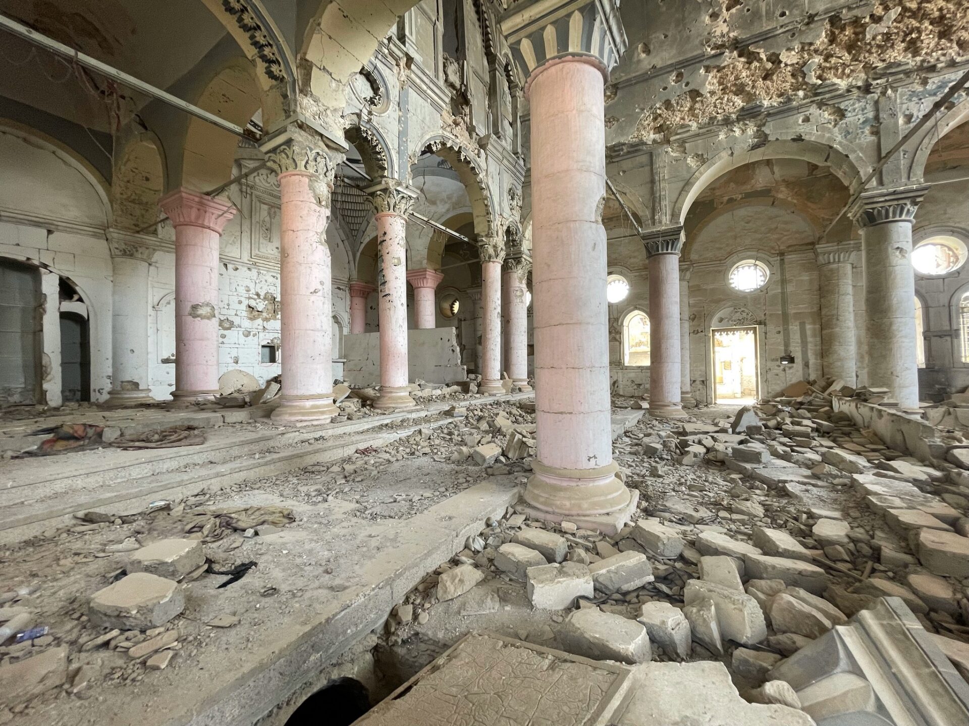 a ruined building with columns and rubble