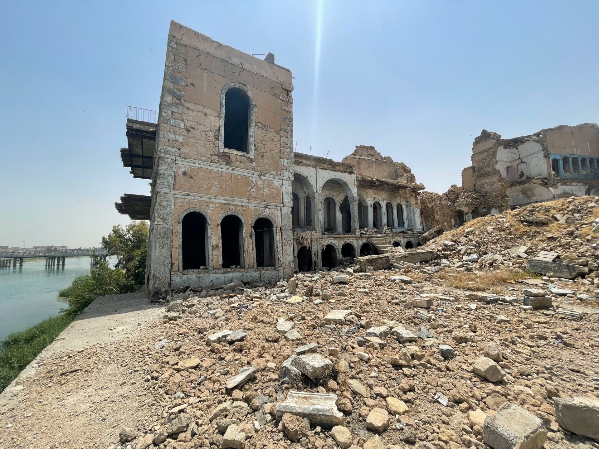 a building with many windows and a rocky hill