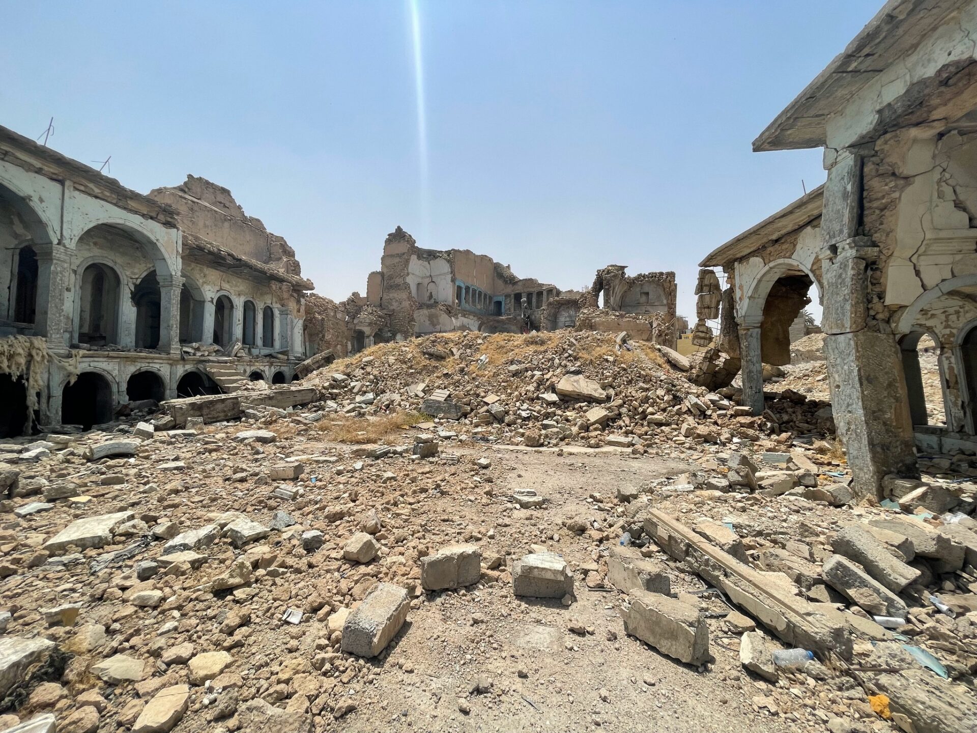 a ruined building with many windows and rubble