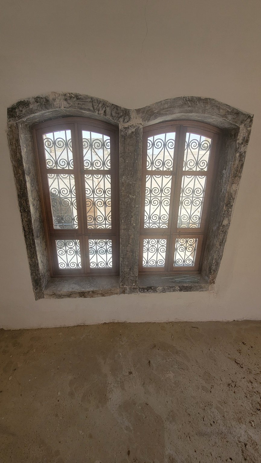 a window with metal bars on the wall