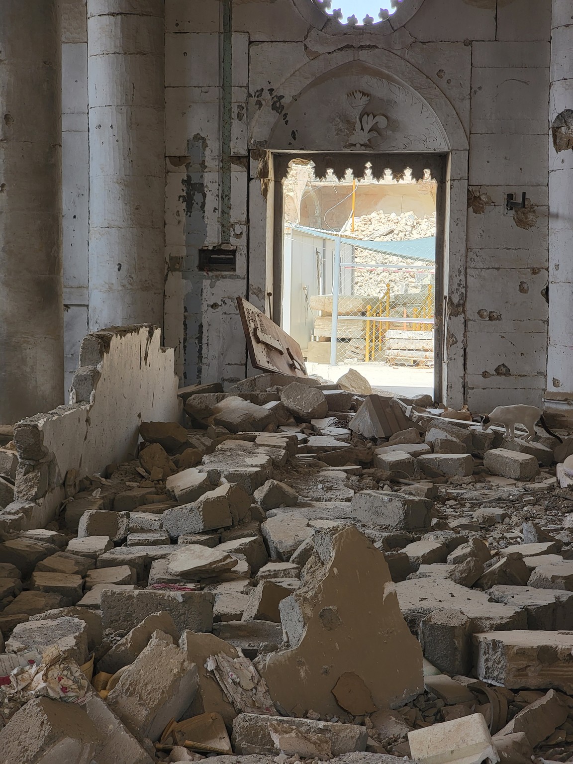 a broken building with rubble in the ground