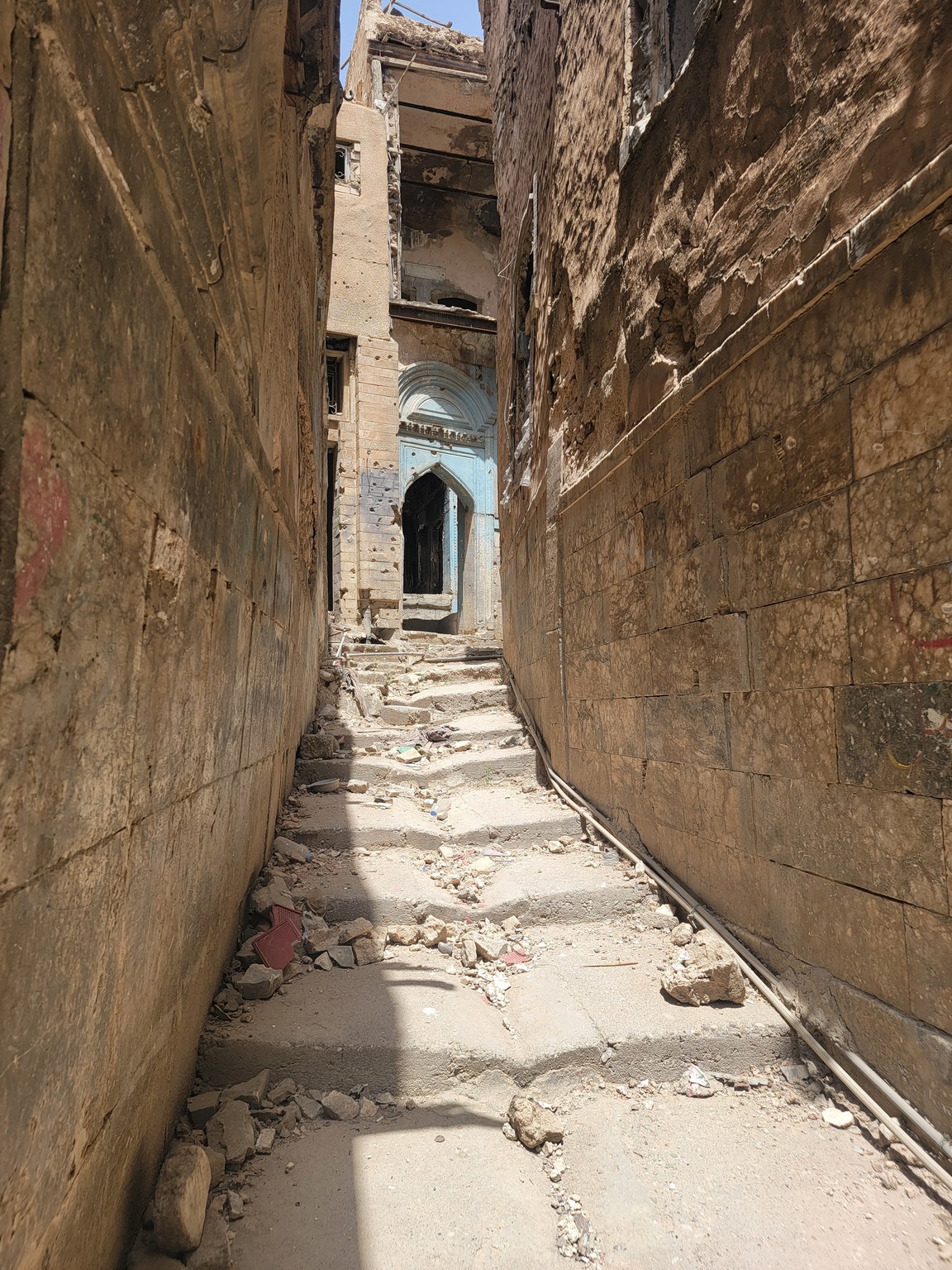 a stone alley way with a doorway and a doorway