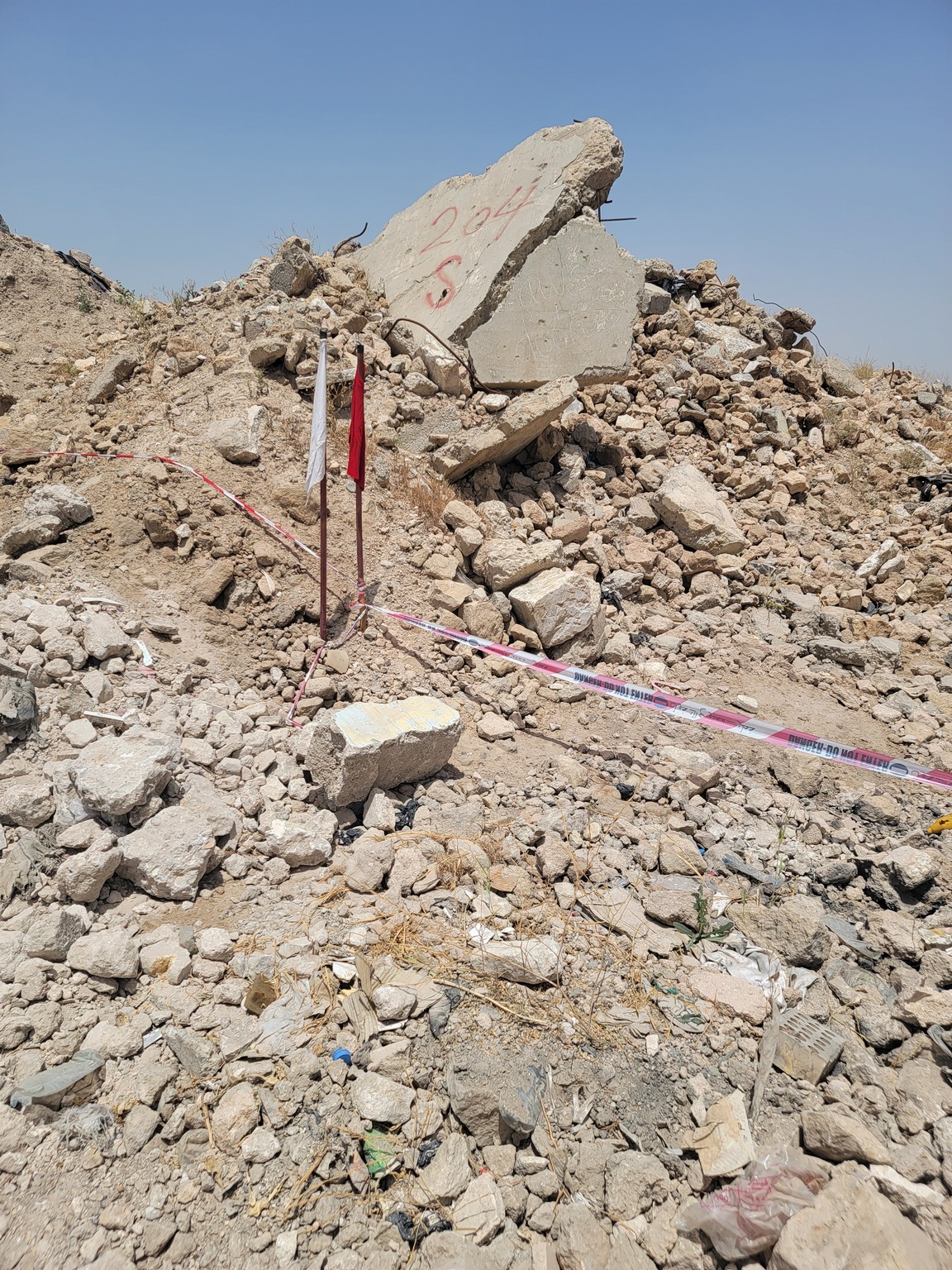 a pile of rocks and rocks with a red and white tape