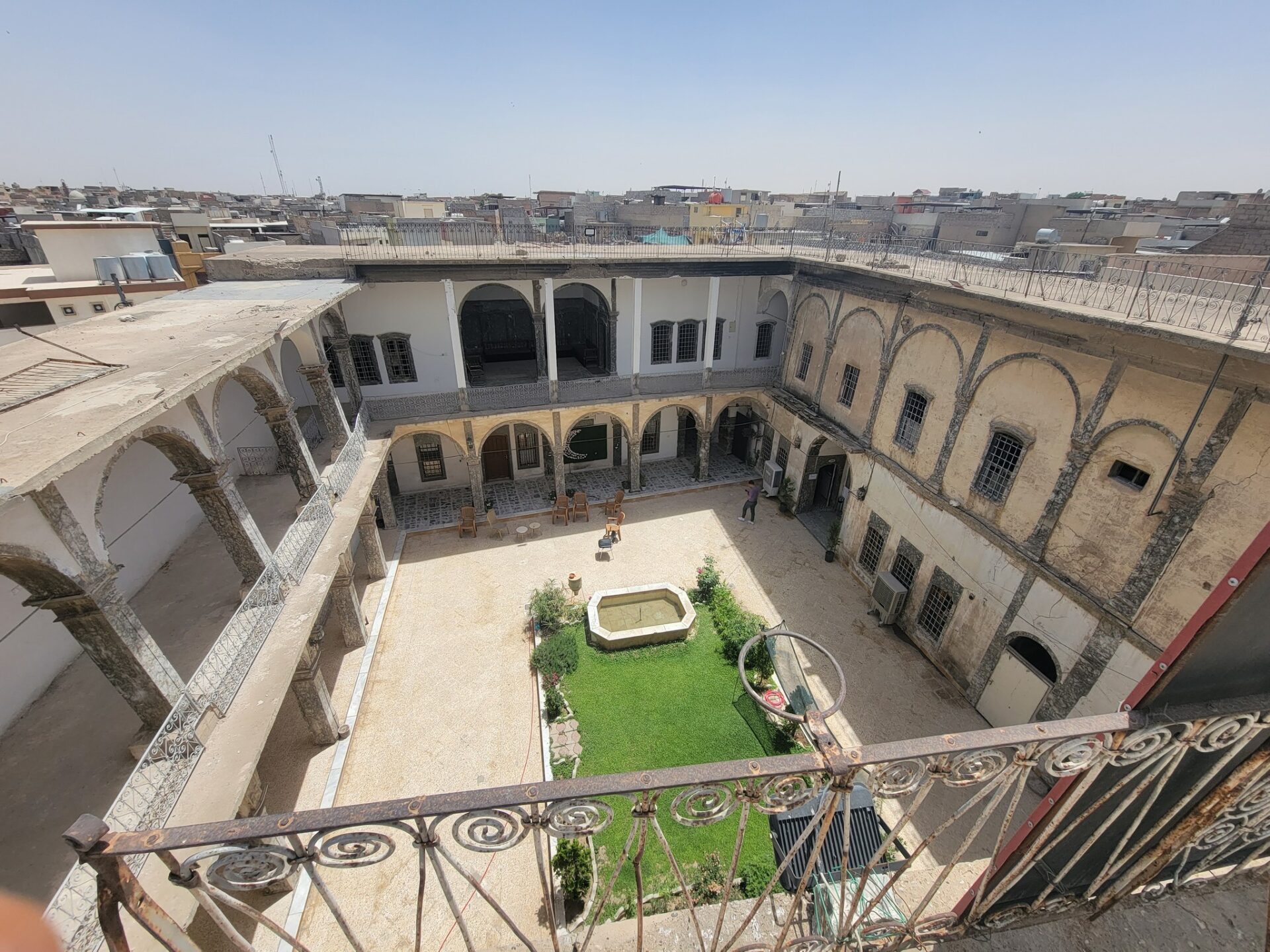 a courtyard with a courtyard and a fence