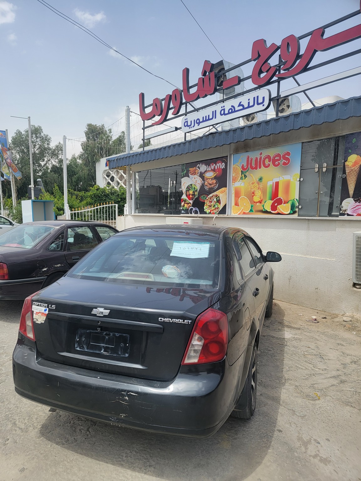 a black car parked in front of a building