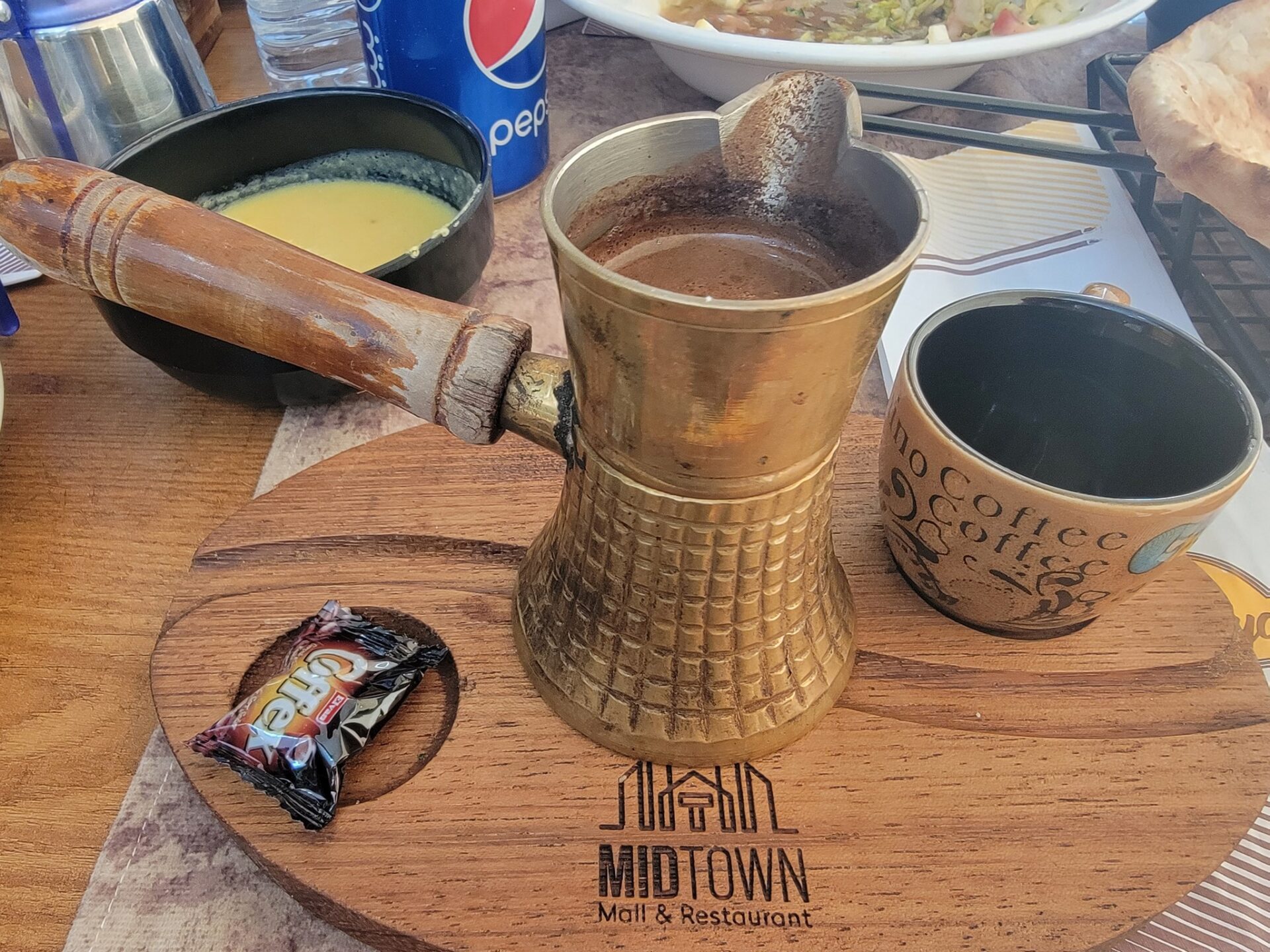 a coffee pot and cups on a wooden tray