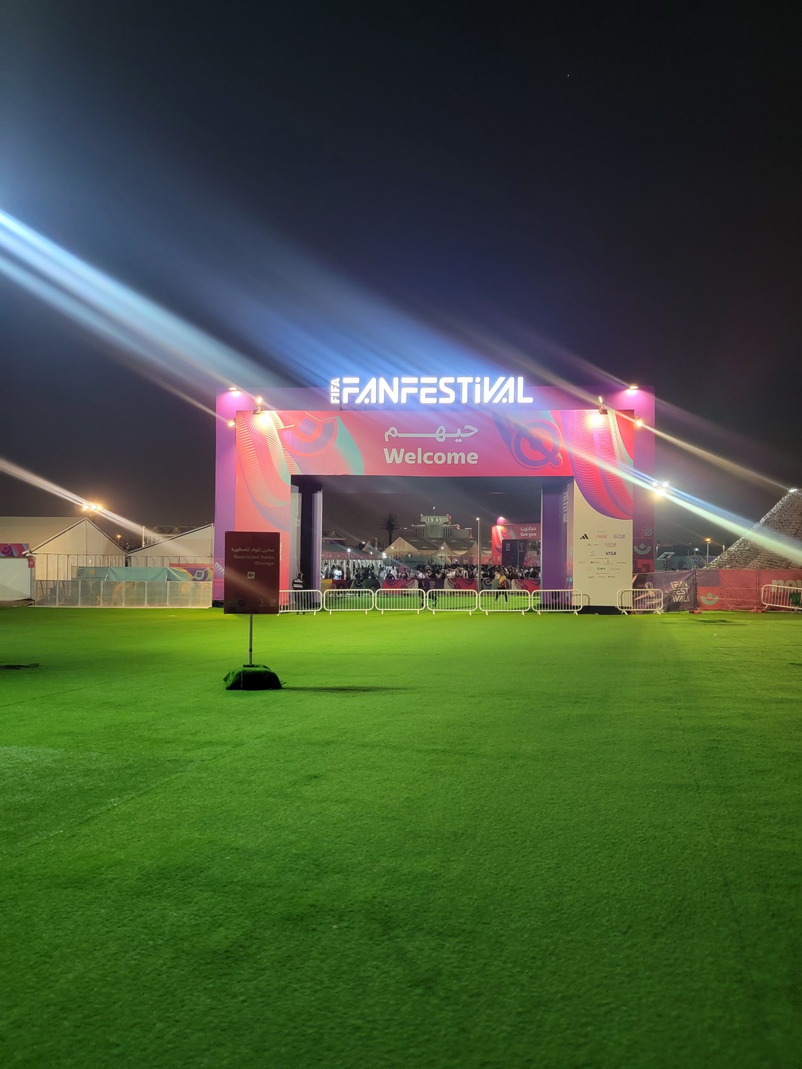 a large green field with lights on the side