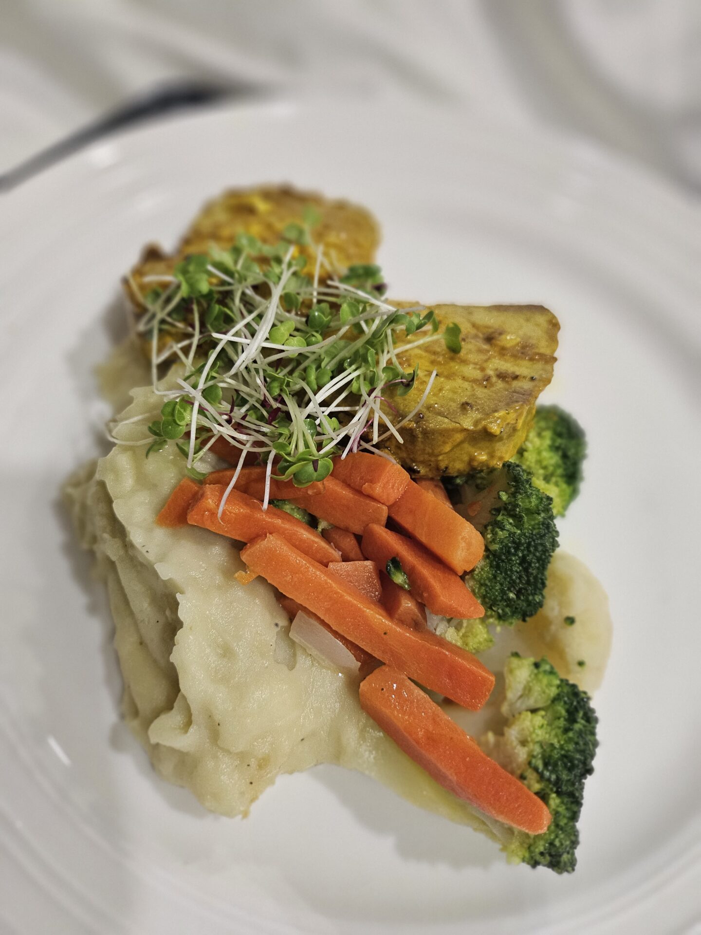 a plate of food with broccoli carrots and potatoes