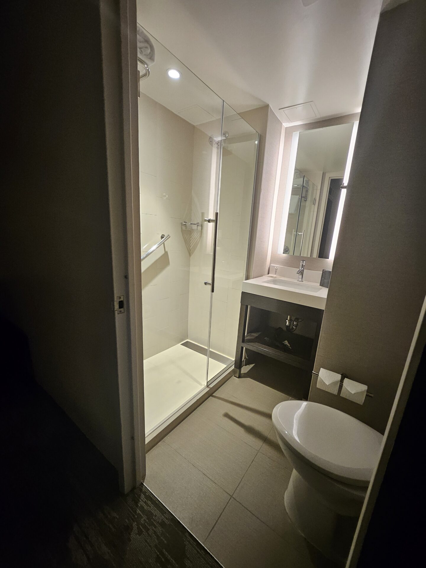 a bathroom with a glass shower and sink