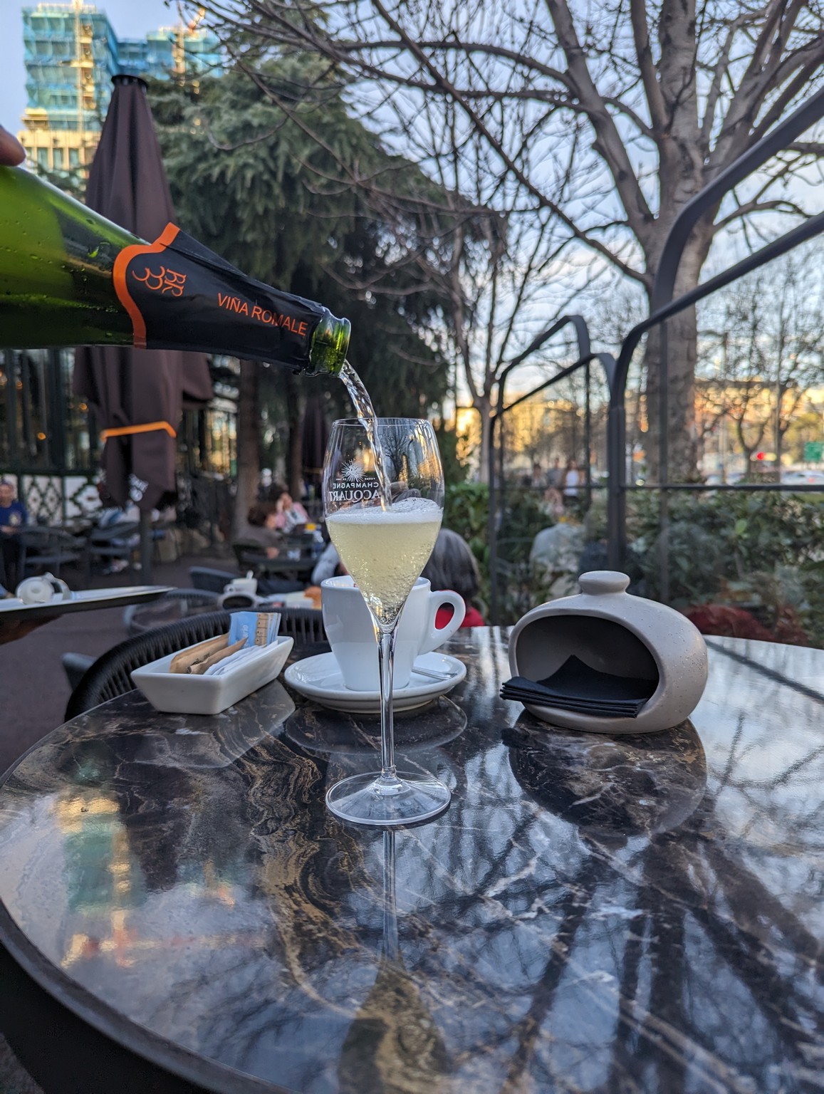 a person pouring a glass of champagne