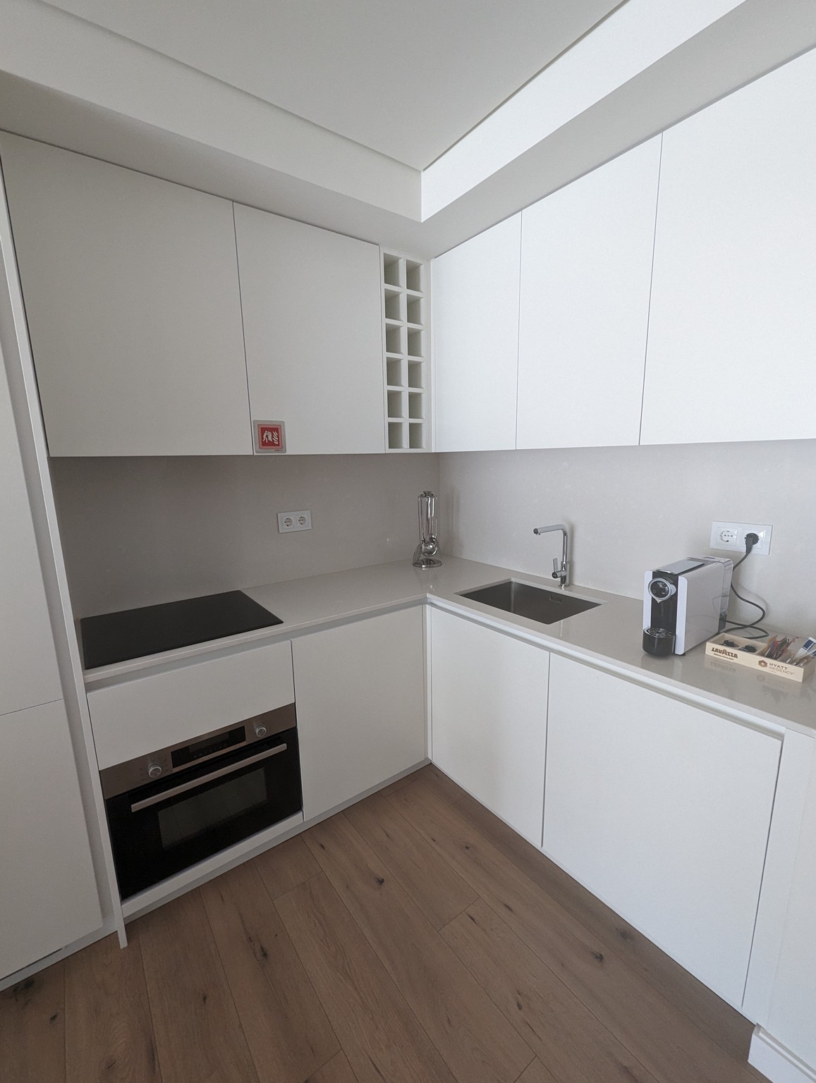 a kitchen with white cabinets and a wood floor