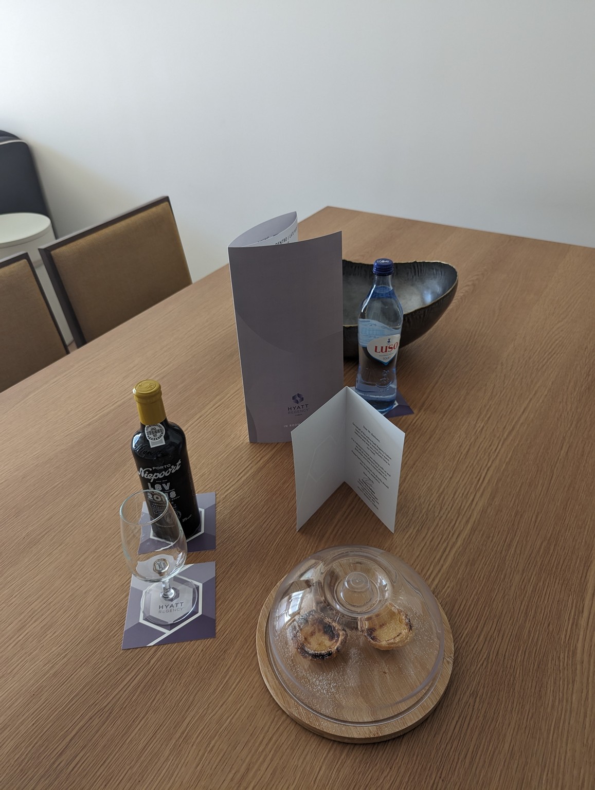 a table with a menu and bottles of wine on it