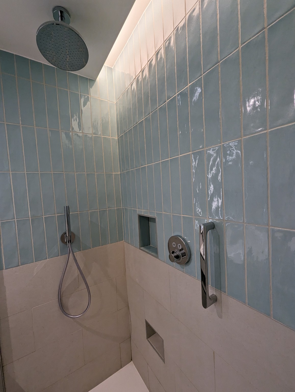 a shower with a shower head and a shower head