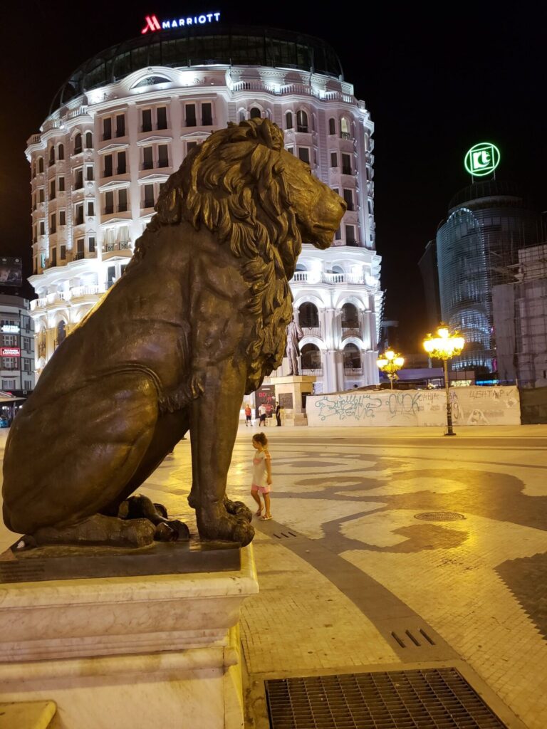 a statue of a lion in a city