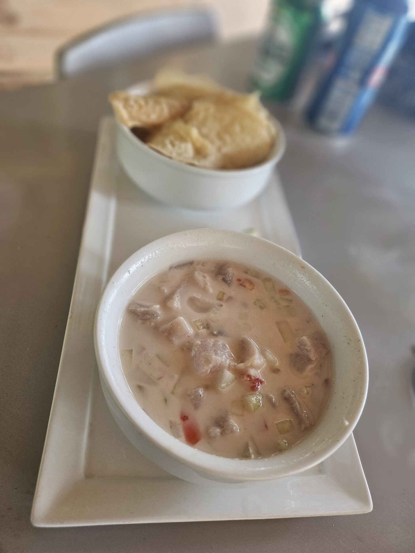 a bowl of soup and a bowl of crackers on a tray