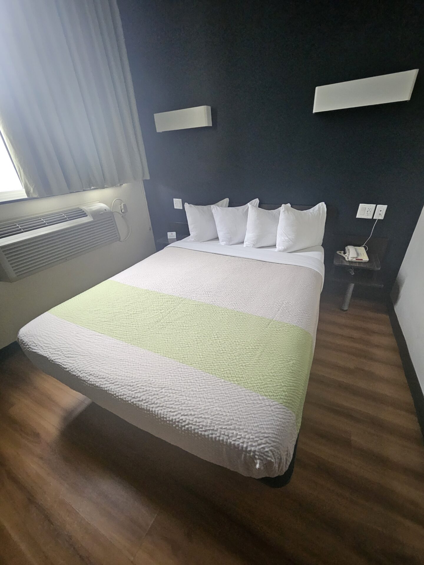 a bed with white and green stripes