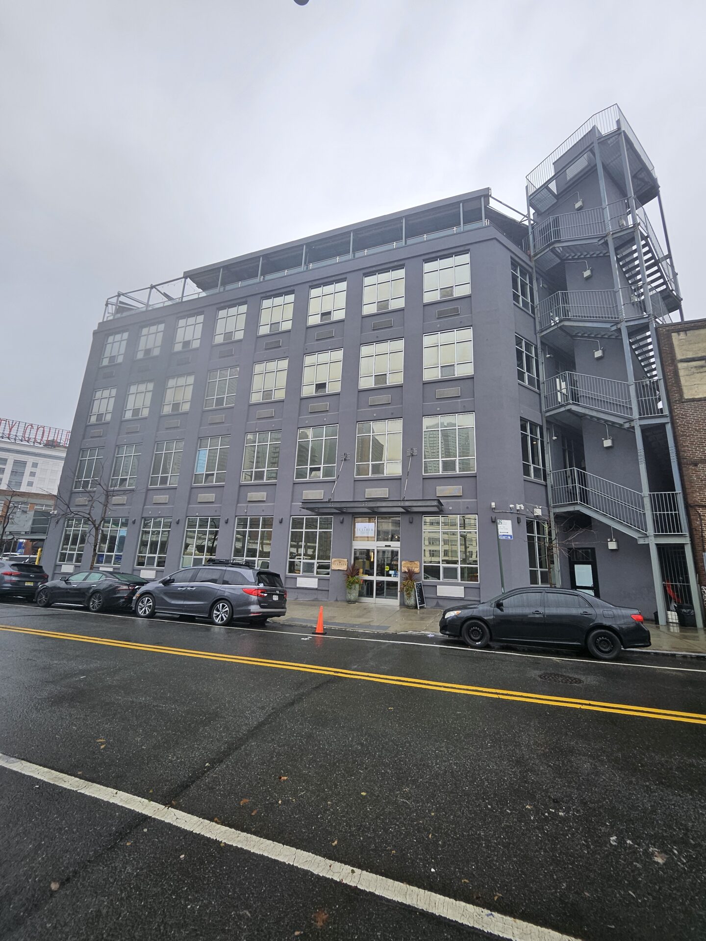 a building with cars parked on the side of the road