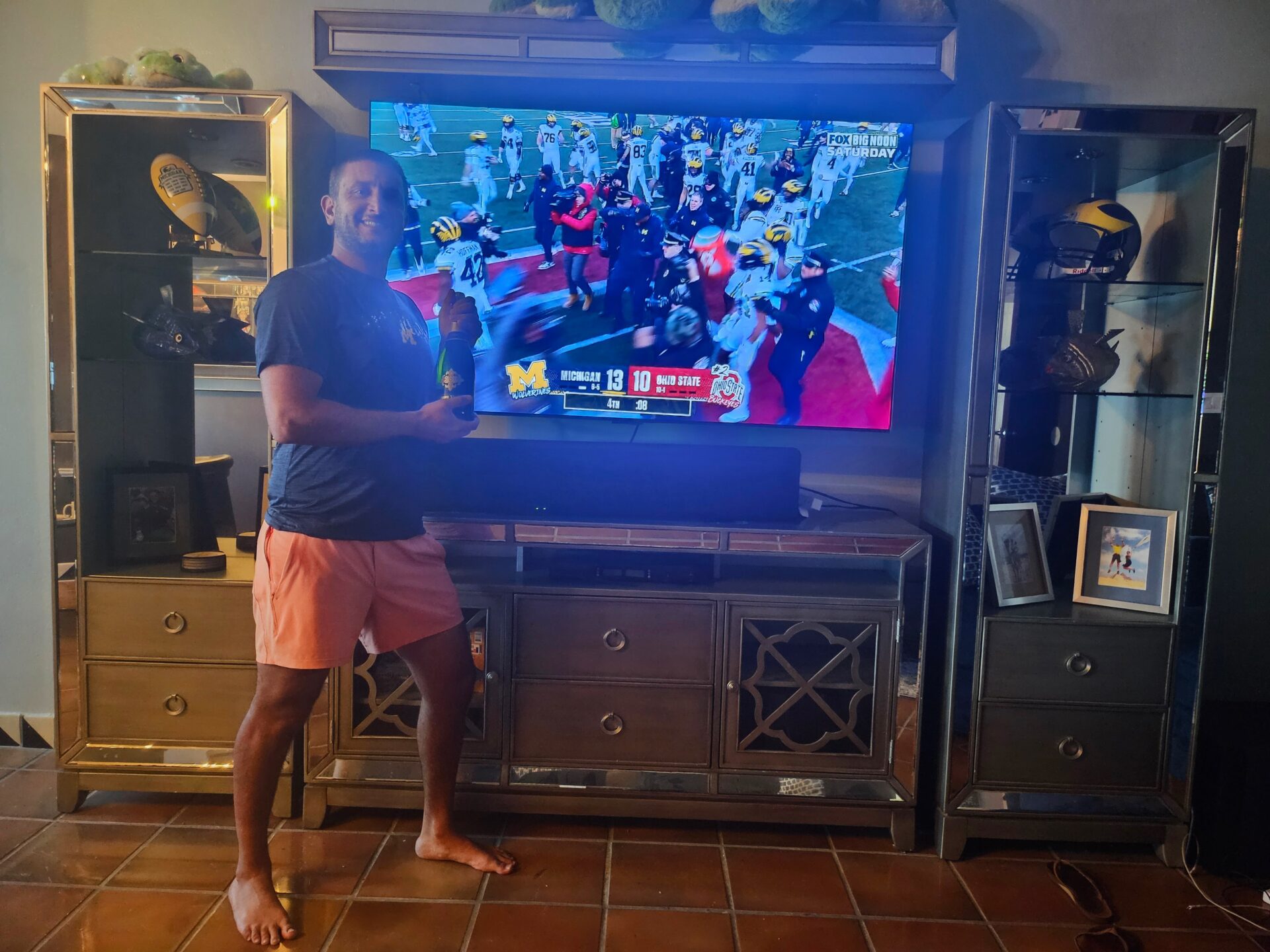 a man standing in front of a television