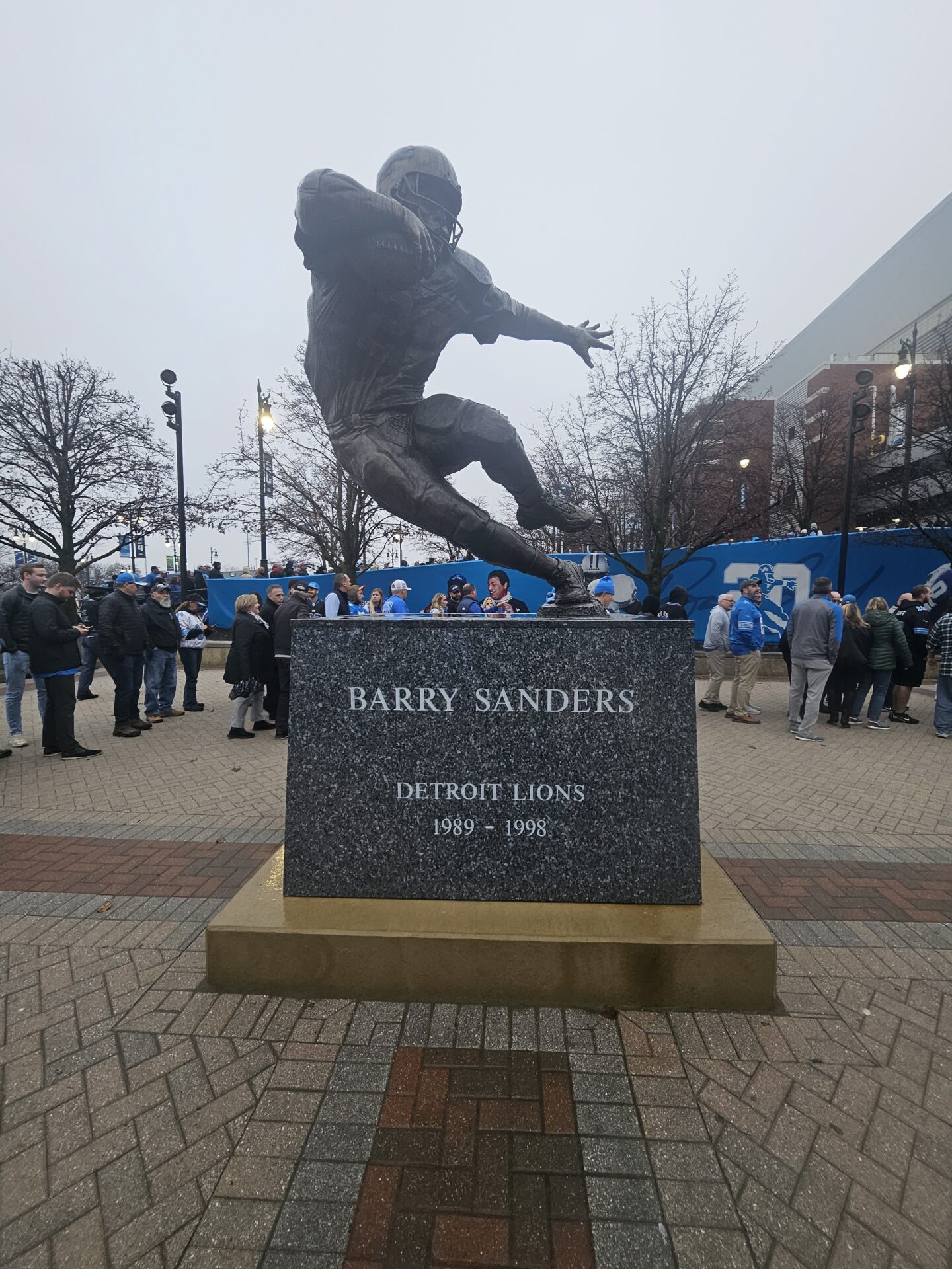 a statue of a football player in front of a crowd of people